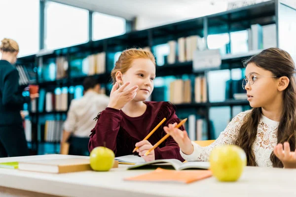 Adorable Schoolgirls Talking While Studying Together Library — Stock Photo, Image