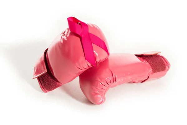 Close-up view of pink boxing gloves and ribbon isolated on white, breast cancer concept — Stock Photo