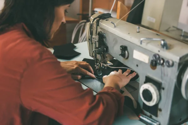 Mature seamstress working with electrical sewing machine — Stock Photo