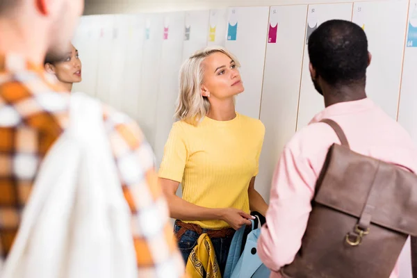 Young students spending time together in college corridor — Stock Photo