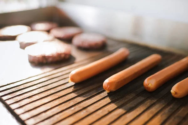 Sausages and meat cutlets for burgers in food truck — Stock Photo