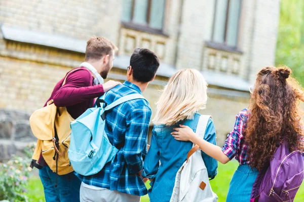 Back view of students with backpacks walking on street — Stock Photo