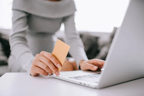 Cropped shot of pregnant woman with credit card and laptop buying goods online at home — Stock Photo