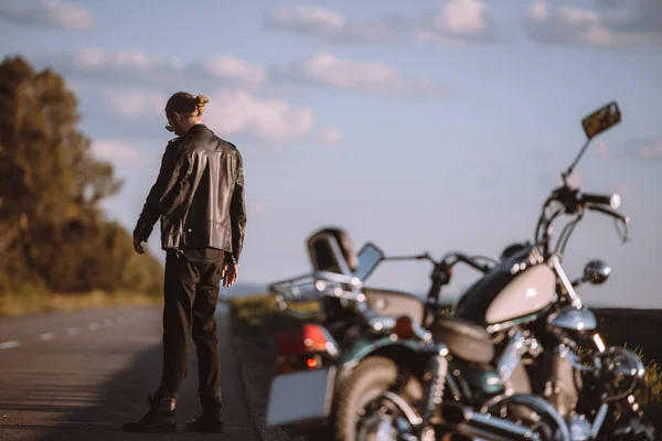 Upset man with broken classic motorcycle on road, selective focus — Stock Photo