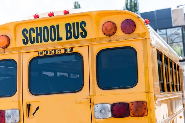 Rear view of school bus with inscription over back door — Stock Photo