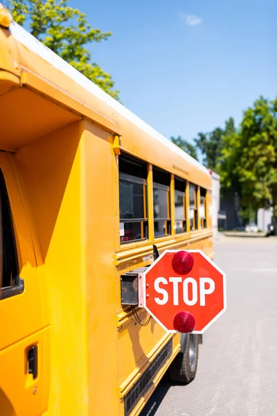 Tiro recortado de ônibus escolar tradicional com sinal de parada — Fotografia de Stock