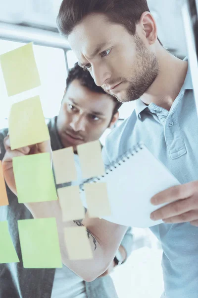 Young concentrated multiethnic businessmen working at new project together — Stock Photo