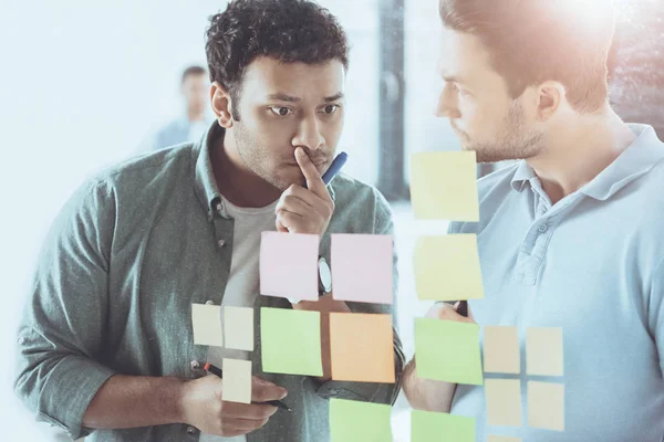 Focused young multiethnic businessmen working at new project in office — Stock Photo