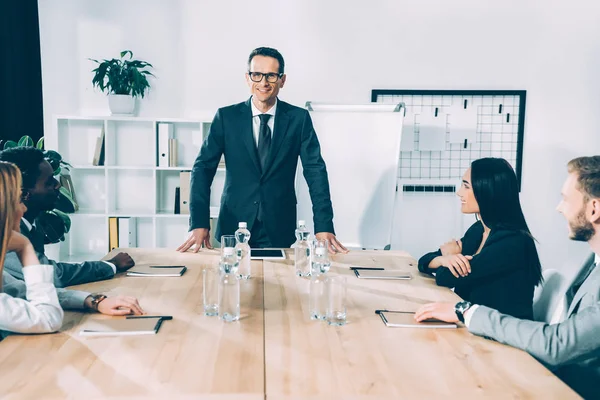 Multiethnic businesspeople having conversation in modern conference hall — Stock Photo
