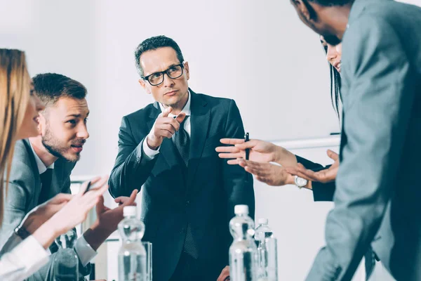 Group of muliethnic businesspeople having conversation in conference hall — Stock Photo