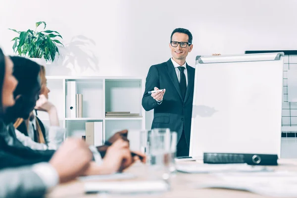 Handsome mature businessman giving presentation at conference hall — Stock Photo