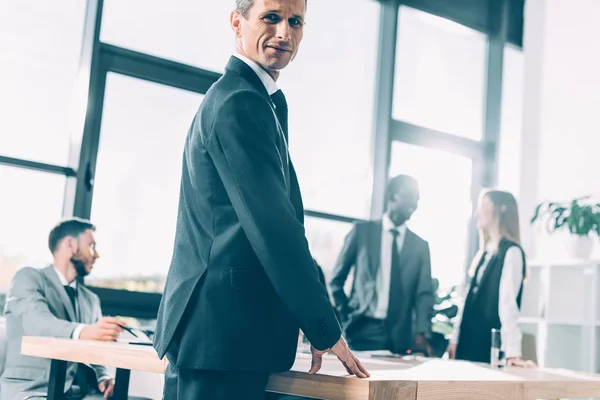 Multiracial business partners in conference hall on bright sunny day — Stock Photo