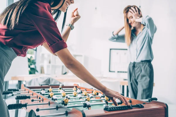 Businesswomen playing table football in modern office — Stock Photo