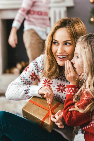 Mother and daughter gossiping and unpacking gift together while sitting on floor — Stock Photo