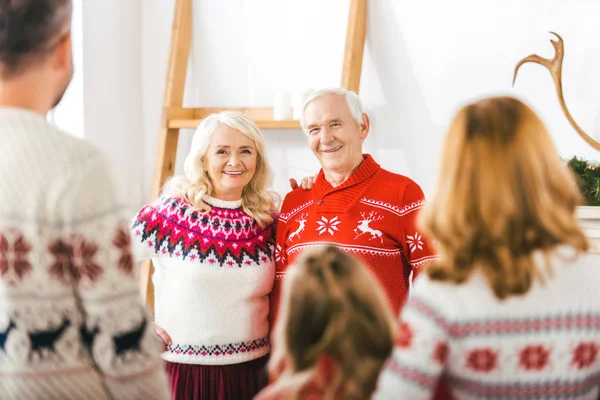 Feliz seniour casal olhando para as crianças no Natal — Fotografia de Stock