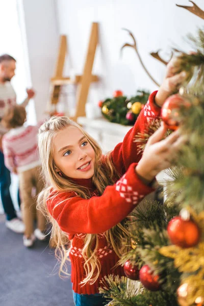 Adorble little child decorating christmas tree — Stock Photo
