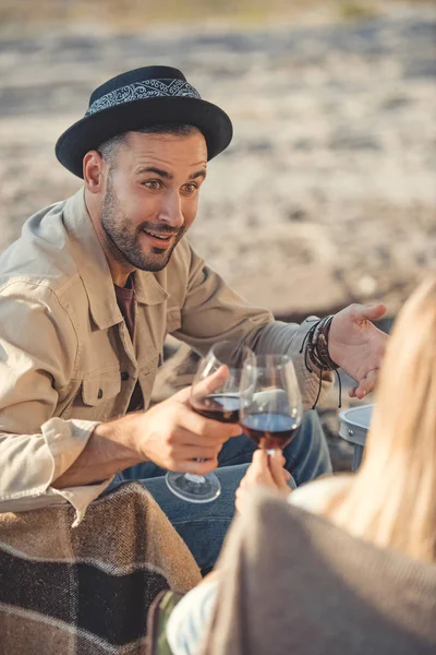 Young happy couple clinking with glasses of wine — Stock Photo