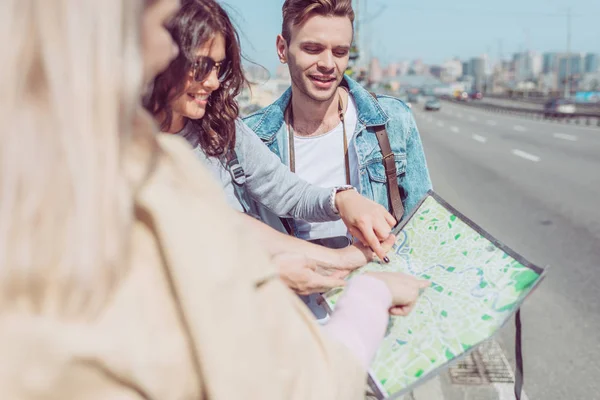 Partial view of tourists looking for destination on map during trip — Stock Photo