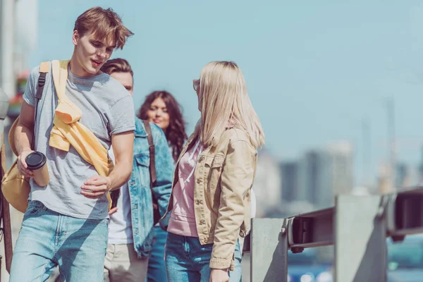 Young travelers walking on street while traveling together — Stock Photo