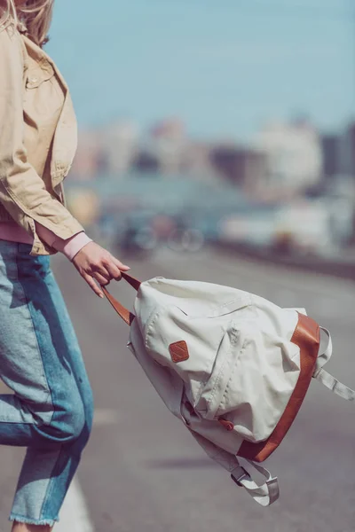 Partial view of female traveler with backpack crossing road in new city — Stock Photo