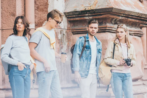 Young stylish travelers walking in city together — Stock Photo