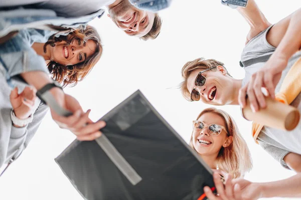 Bottom view of smiling travelers looking at map in city — Stock Photo