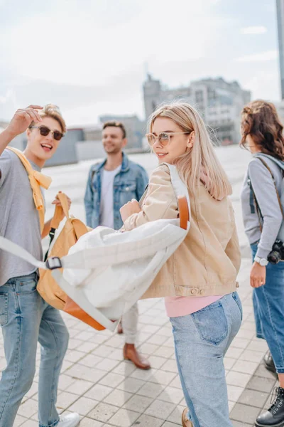 Young stylish friends walking in city — Stock Photo