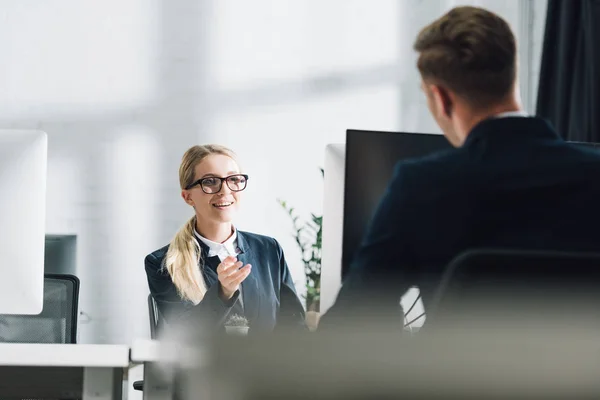 Selective focus of young business people talking in office — Stock Photo