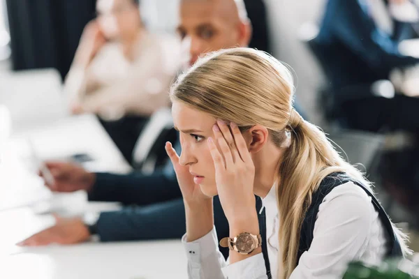 Side view of stressed young businesswoman looking away in office — Stock Photo