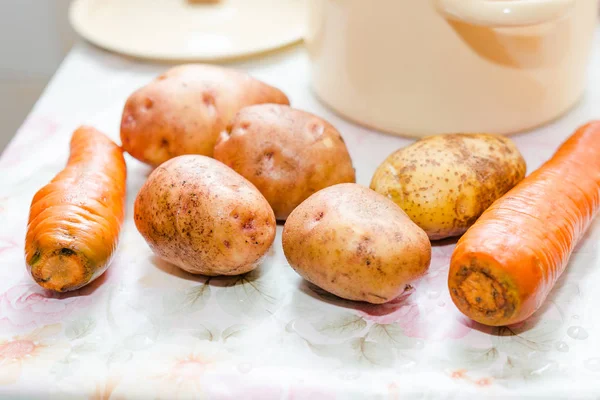 The washed potatoes on a table. Pure potatoes lie on a table