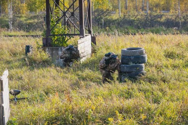 Game in a paintball. To shoot balls with paint. Firing in a paintball. Active game.