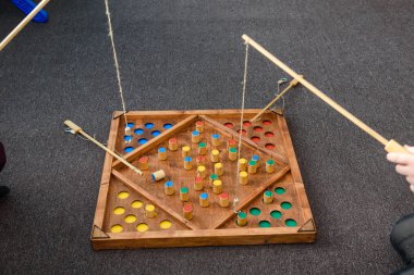 Çocuk oyunları ile renkli şekiller. Ahşap bir şekil üzerinde yem yakalamak. Rakamlar yerlerde yerleştirin. Çocuklar için oyunlar eğitim