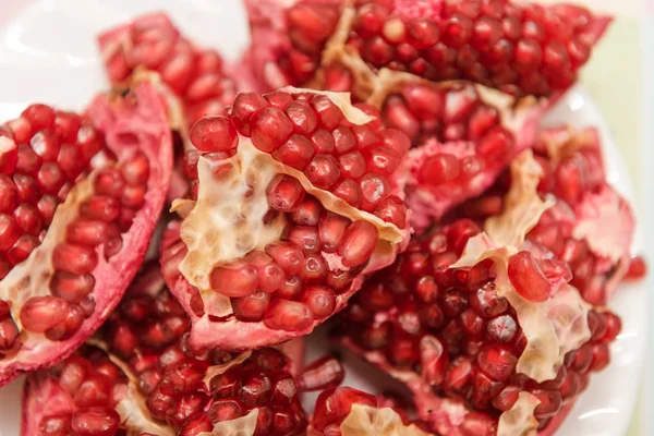 Pomegranate on a white background. Natural fruit. Red fruit. Pomegranate on the table. Pomegranate fruit.