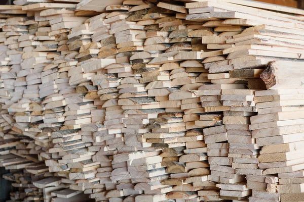 Timber at work. Lumber stockpiled. The boards are stacked. Boards for sale in stock. Lumber.