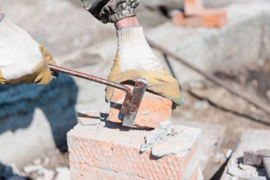 Çimentodaki tuğla Tuğladan yapılma. Tuğla bir duvarı yıkıyorum. Temiz tuğlalar. Çimentoyu kaldırın. İnşaat. Sıkı çalışma.
