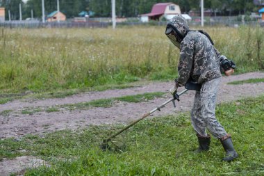 Adam çimleri biçiyor. Çimleri biçme makinesiyle kes. Adam bahçeyi temizliyor. Mesleğiniz? Tarım. Bölgeyi temizliyorum. Çimleri kesin.