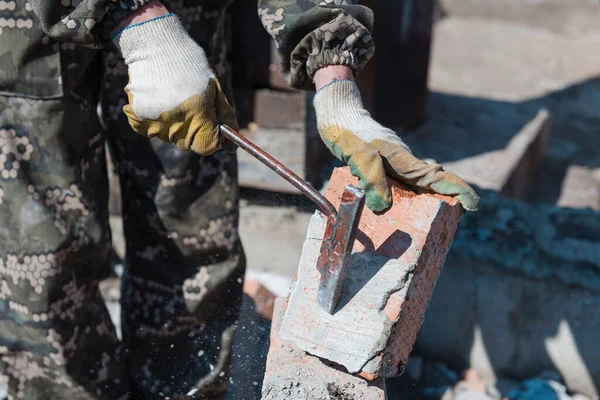 Brick in cement. Remove cement. Breaking down a brick wall. Knocking on bricks. Remove brick fragments. Cleaning the area from debris. Construction of a brick fence. Hard work
