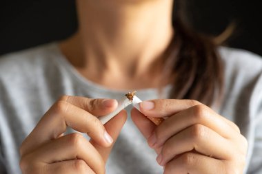 Dünya Hayır Tütün gün, 31 Mayıs. Sigarayı bırakmak. Kırma, kırma veya siyah arka plan üzerine sigara yok kadın el kadar kapatın.