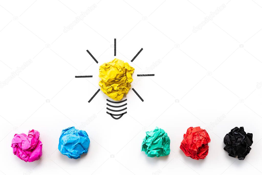 Inspiration and great idea concept. light bulb with crumpled colorful paper on white background.