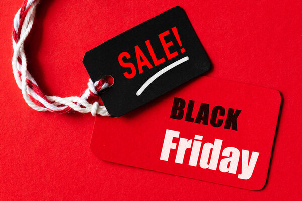 Black Friday Sale text on a red and black tag. Shopping concept.