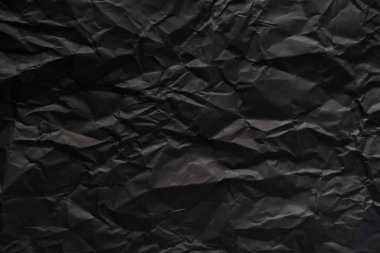 Siyah buruşmuş kağıt dokusu arkaplanı.