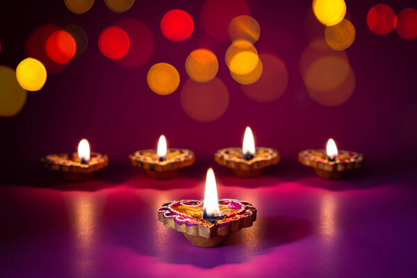 Happy Diwali - Clay Diya lamps lit during Dipavali, Hindu festival of lights celebration