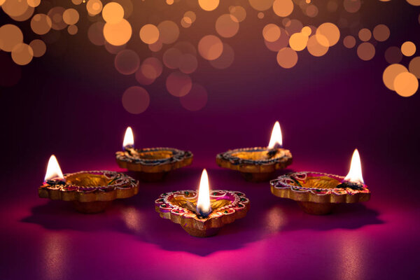 Happy Diwali - Clay Diya lamps lit during Dipavali, Hindu festival of lights celebration