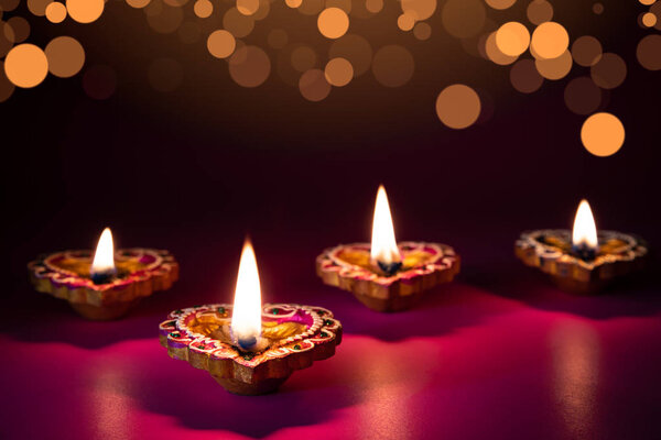 Happy Diwali - Clay Diya lamps lit during Dipavali, Hindu festival of lights celebration