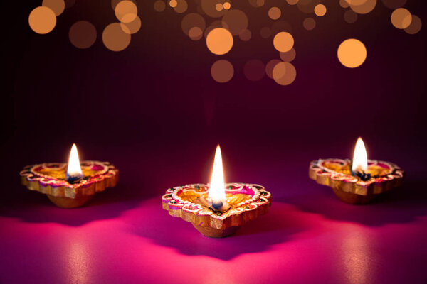 Happy Diwali - Clay Diya lamps lit during Dipavali, Hindu festival of lights celebration