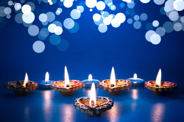 Happy Diwali - Clay Diya lamps lit during Dipavali, Hindu festival of lights celebration