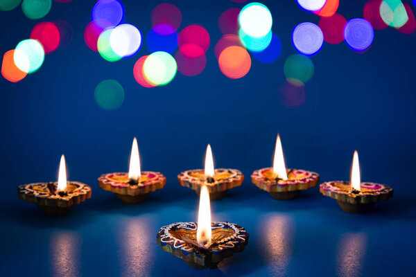 Happy Diwali - Clay Diya lamps lit during Dipavali, Hindu festival of lights celebration