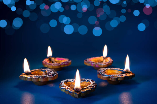 Happy Diwali - Clay Diya lamps lit during Dipavali, Hindu festival of lights celebration