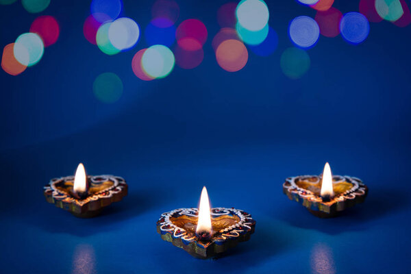 Happy Diwali - Clay Diya lamps lit during Dipavali, Hindu festival of lights celebration
