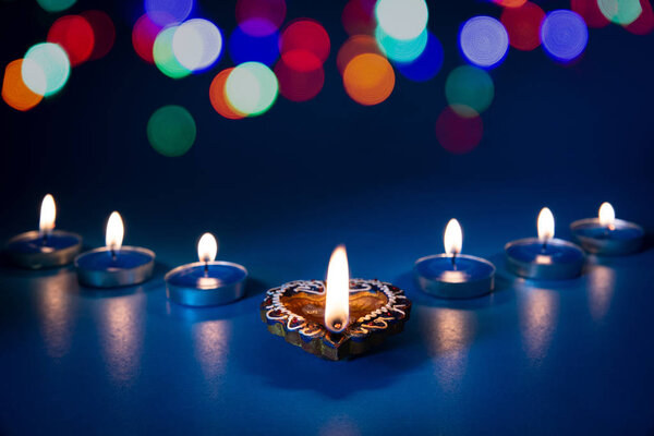 Happy Diwali - Clay Diya lamps lit during Dipavali, Hindu festival of lights celebration